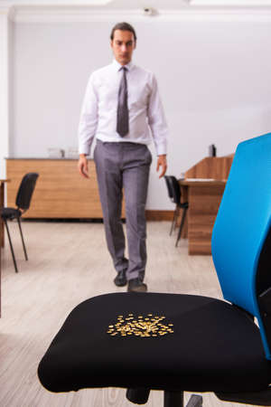 Office prank with sharp thumbtacks on chair
