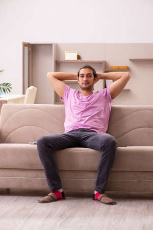 Young man staying at home during pandemicの写真素材