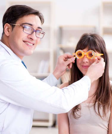 Ophthalmologist is checking up patient in eye doctor hospitalの写真素材