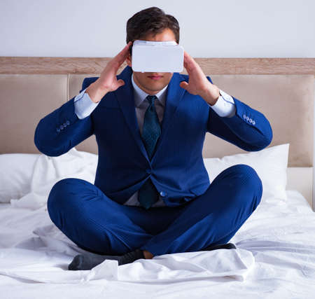 Businessman wearing a virtual reality headset in the bedroomの写真素材