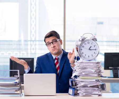 Businessman employee in urgency and deadline concept with alarmの写真素材