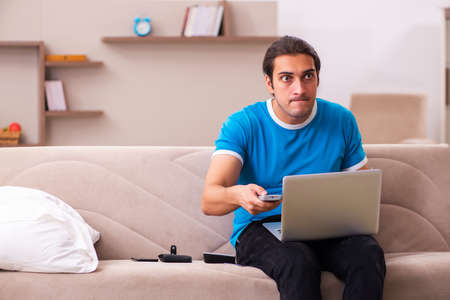 Sport bet addicted young man betting at homeの写真素材