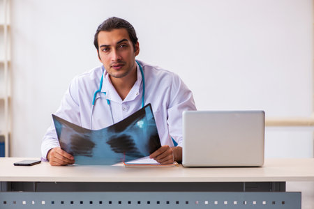 Young male doctor radiologist working in the clinicの写真素材