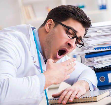 Busy doctor with too much work in hospitalの写真素材