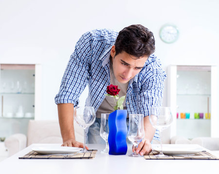 Man alone preparing for romantic date with his sweetheartの写真素材