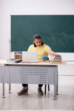 Young male student preparing for exams in the classroomの写真素材