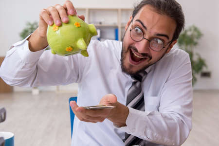 Young male bookkeeper in retirement conceptの写真素材