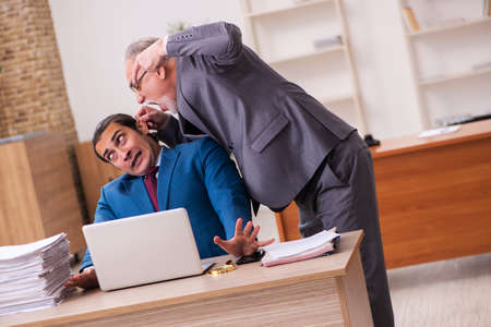 Two employees working in the officeの写真素材