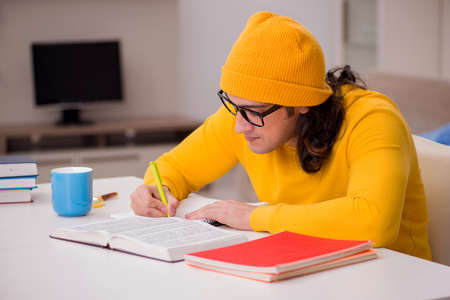 Young male student preparing for exams at homeの写真素材