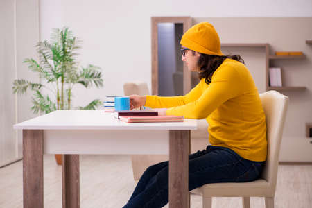 Young male student preparing for exams at homeの写真素材