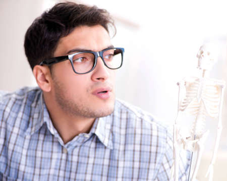 Medical student studing the skeleton