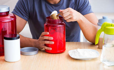 Athlete tasting new protein supplements for better musclesの写真素材