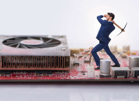 Cryptocurrency concept with businessman mining moneyの写真素材