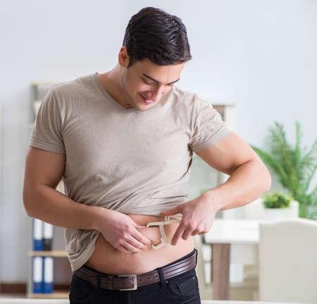Man measuring body fat with calipersの写真素材