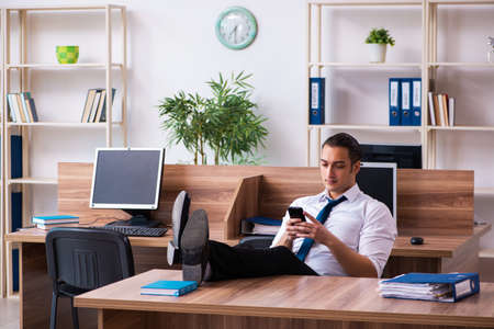 Young male employee working in the officeの写真素材