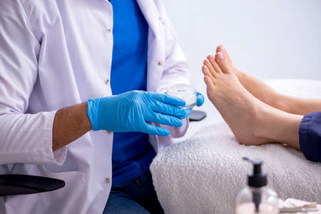 Podiatrist treating feet during procedureの写真素材