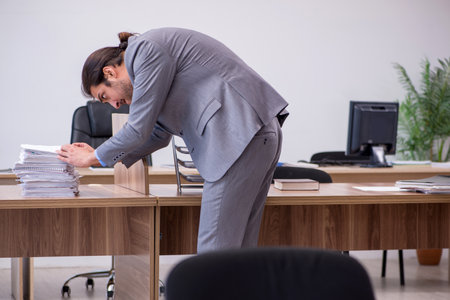 Young male employee in industrial espionage conceptの写真素材