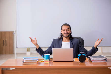 Young male teacher in the classroom