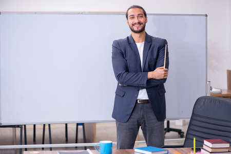 Young male teacher in the classroomの写真素材