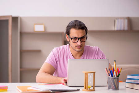 Young male student in time management concept