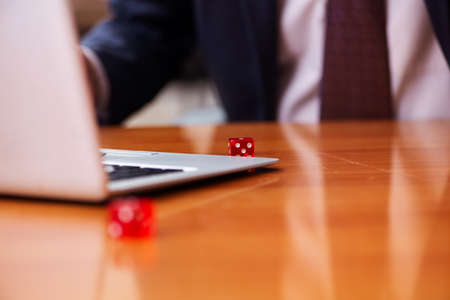 Old male employee in gambling concept at workplaceの写真素材