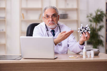 Experienced male doctor working in the clinicの写真素材