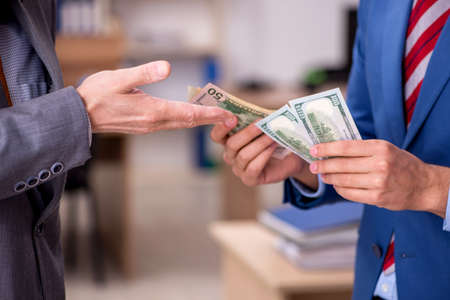 Two male employees in remuneration concept