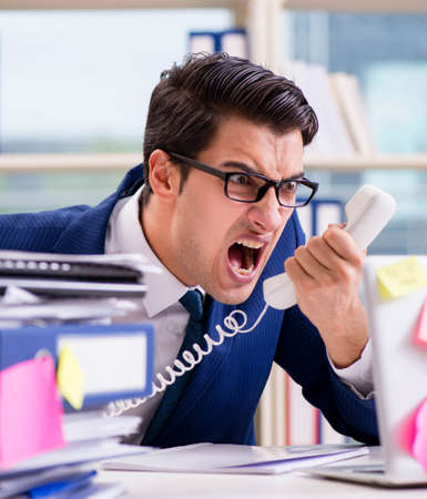 Businessman with reminder notes in multitasking conceptの写真素材