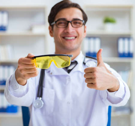 Safety doctor advising about wearing protective gogglesの写真素材