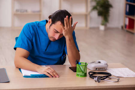 Young male doctor working in the clinicの写真素材