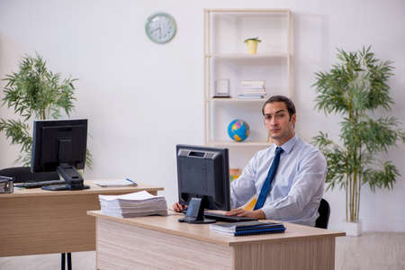 Young male employee sitting in the officeの写真素材