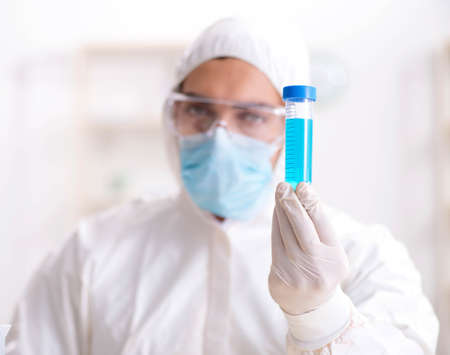 Young chemist student working in lab on chemicals