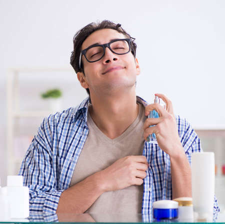 Young man is getting prepared for working day in bathroomの写真素材