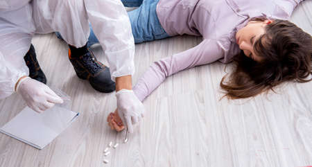Forensic investigator at the crime scene investigating woman mur