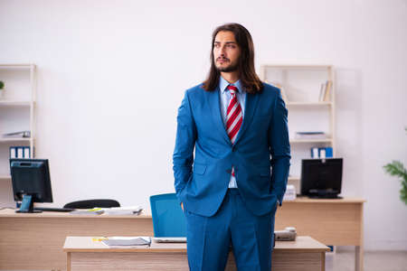Young male employee working at workplaceの写真素材