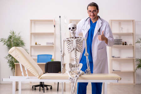 Young male doctor and skeleton patient in the clinicの写真素材