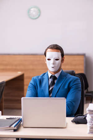 Young male employee wearing masks in the officeの写真素材