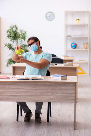 Young man in expensive education concept during pandemicの写真素材