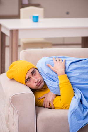 Young man suffering at homeの写真素材