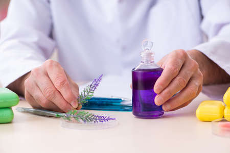 Old male chemist testing soap in the labの写真素材