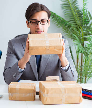 Business people receiving new mail and parcelsの写真素材