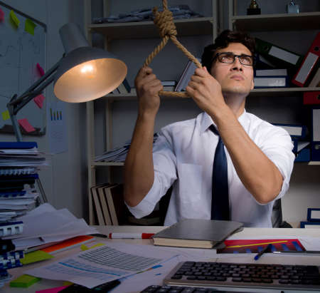 Man businessman working late hours in the office