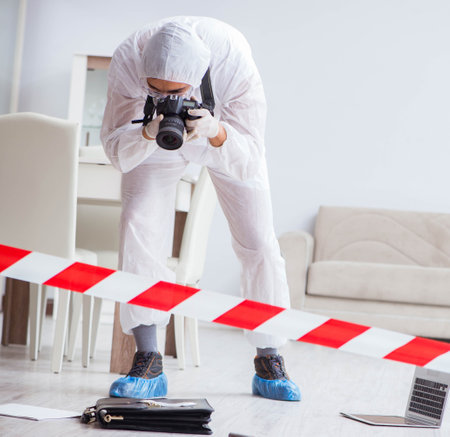Forensic expert at crime scene doing investigationの写真素材
