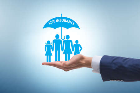 Life insurance concept with family under umbrellaの写真素材