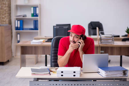 Young male pizza guy in industrial espionage conceptの写真素材