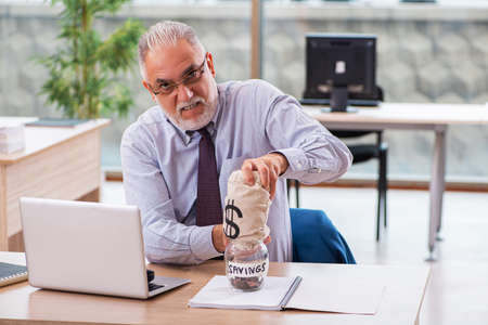 Old male boss employee in retirement conceptの写真素材
