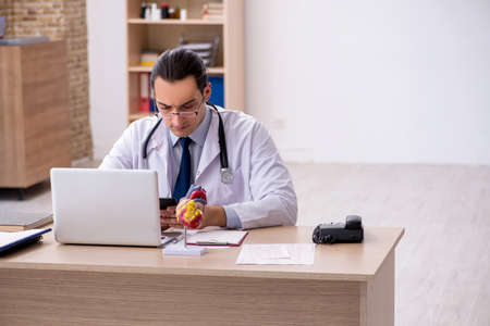 Young male doctor lecturer cardiologist working in the clinicの写真素材