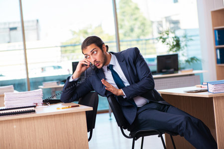 Young male employee working in the officeの写真素材