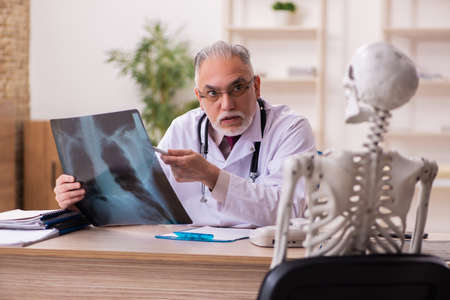 Dead patient visiting old male doctor radiologist