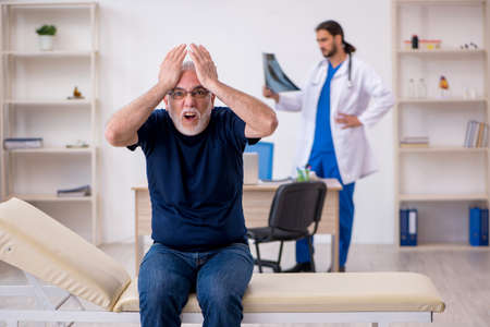 Old male patient visiting young male doctor radiologistの写真素材